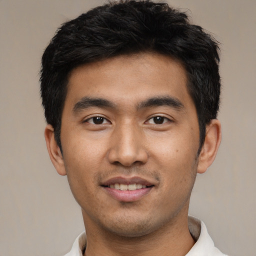 Joyful asian young-adult male with short  black hair and brown eyes