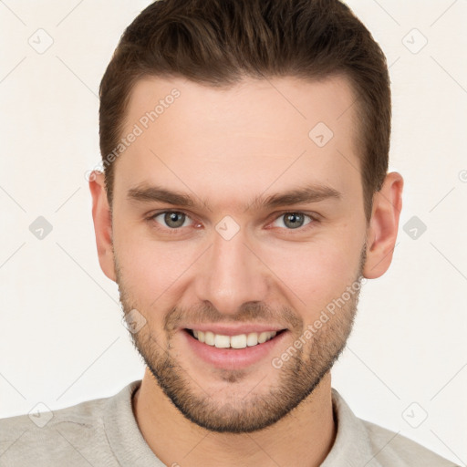 Joyful white young-adult male with short  brown hair and brown eyes