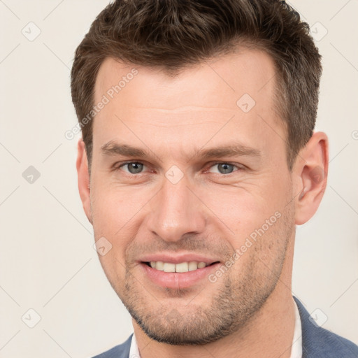 Joyful white young-adult male with short  brown hair and grey eyes