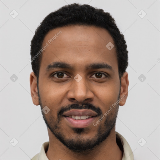 Joyful black young-adult male with short  black hair and brown eyes