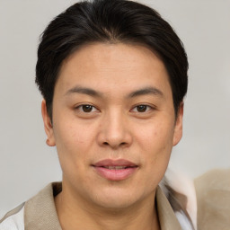 Joyful asian young-adult male with short  brown hair and brown eyes