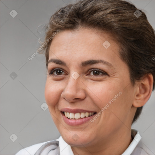 Joyful white young-adult female with short  brown hair and brown eyes