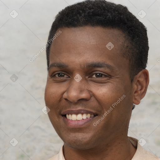 Joyful black young-adult male with short  brown hair and brown eyes