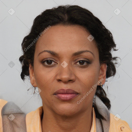 Joyful black adult female with medium  brown hair and brown eyes