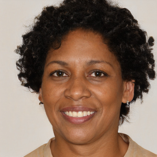 Joyful black adult female with short  brown hair and brown eyes