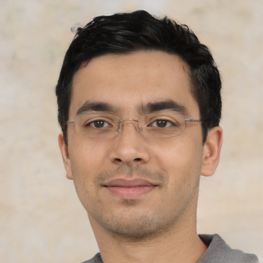 Joyful asian young-adult male with short  black hair and brown eyes