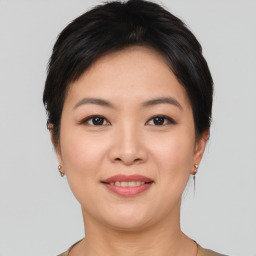 Joyful asian young-adult female with short  brown hair and brown eyes