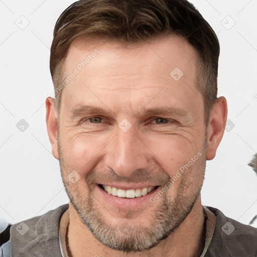 Joyful white adult male with short  brown hair and brown eyes