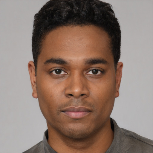 Neutral black young-adult male with short  black hair and brown eyes
