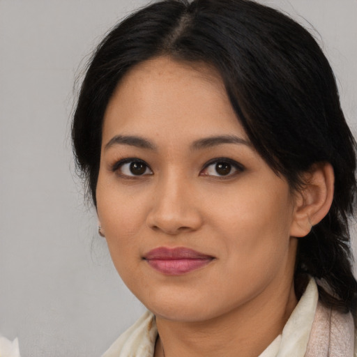 Joyful latino young-adult female with medium  black hair and brown eyes