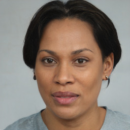 Joyful black adult female with short  brown hair and brown eyes