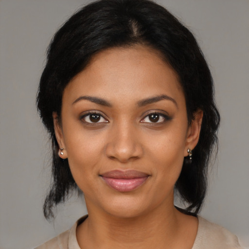 Joyful black young-adult female with medium  black hair and brown eyes