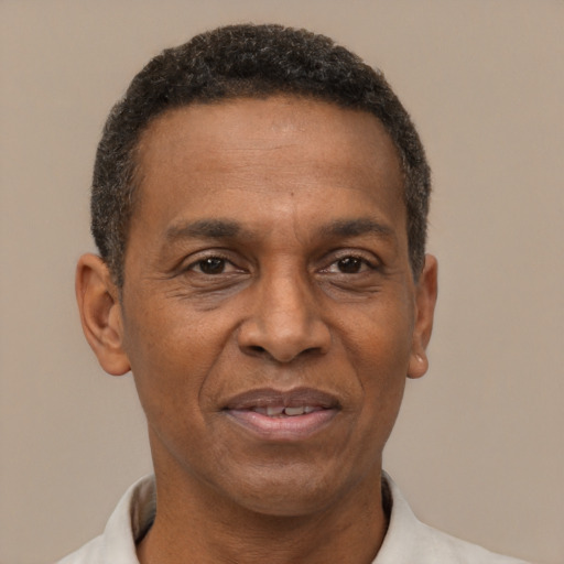 Joyful latino adult male with short  brown hair and brown eyes