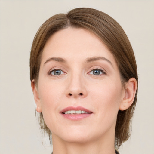 Joyful white young-adult female with medium  brown hair and grey eyes