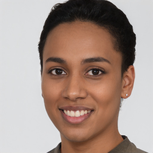 Joyful latino young-adult female with short  black hair and brown eyes