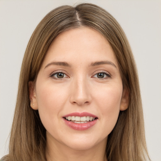 Joyful white young-adult female with long  brown hair and brown eyes