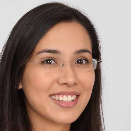 Joyful latino young-adult female with long  brown hair and brown eyes