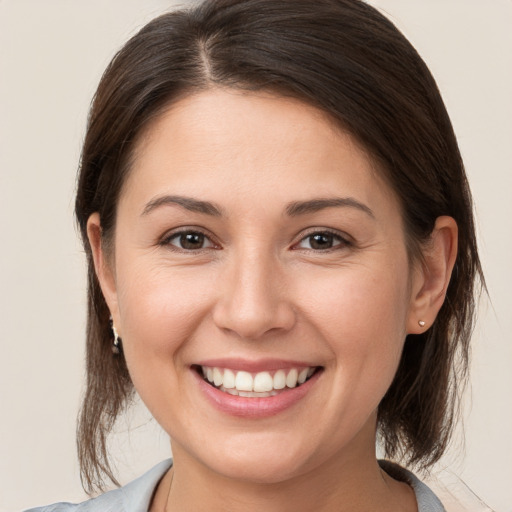 Joyful white young-adult female with medium  brown hair and brown eyes