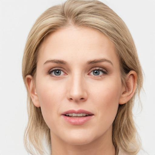 Joyful white young-adult female with medium  brown hair and blue eyes