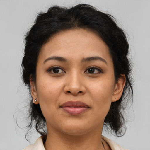 Joyful latino young-adult female with medium  brown hair and brown eyes