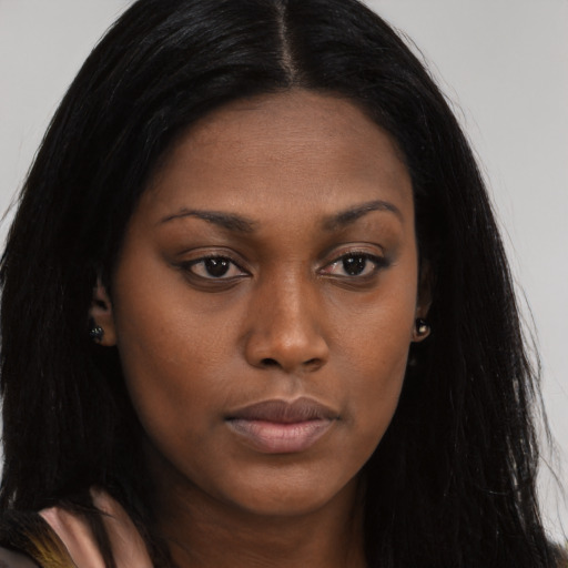 Neutral black young-adult female with long  brown hair and brown eyes