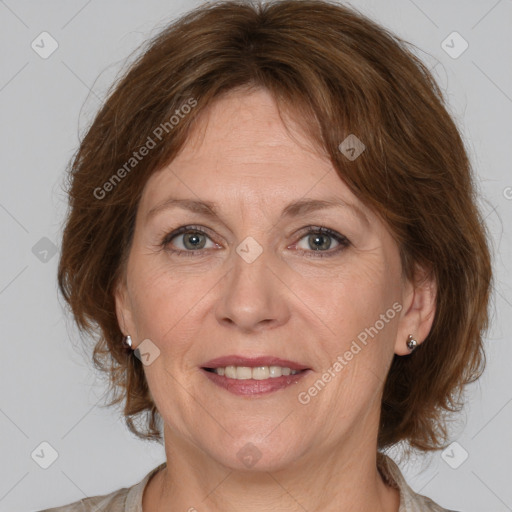 Joyful white adult female with medium  brown hair and grey eyes