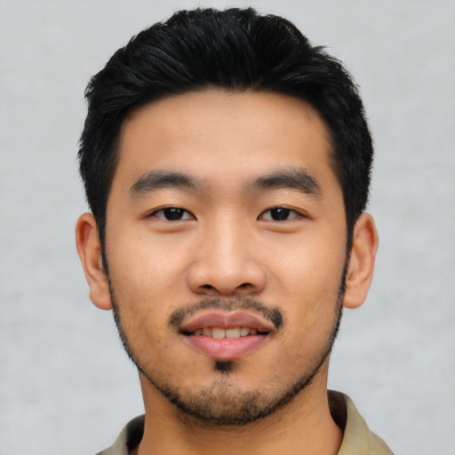 Joyful asian young-adult male with short  black hair and brown eyes