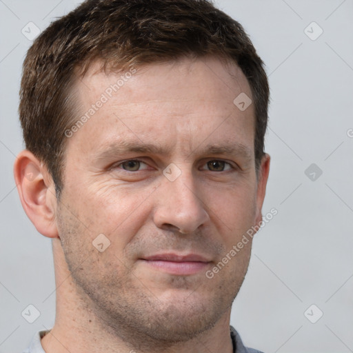 Joyful white adult male with short  brown hair and grey eyes