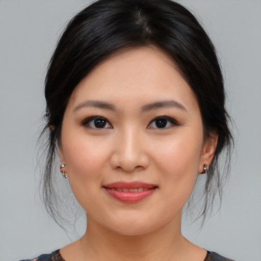 Joyful asian young-adult female with medium  brown hair and brown eyes
