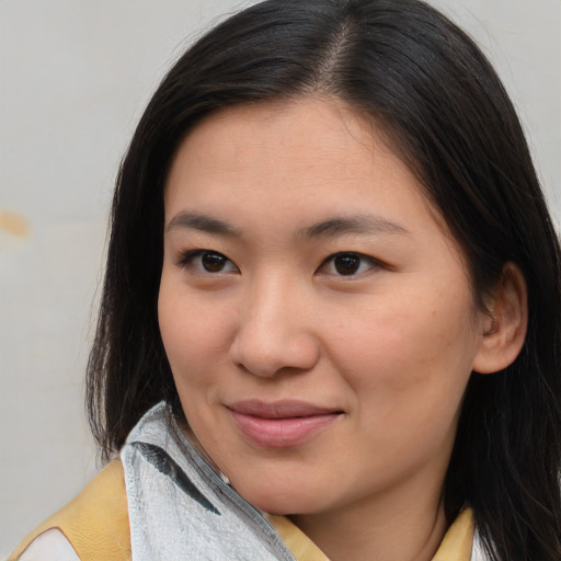 Joyful asian young-adult female with medium  brown hair and brown eyes