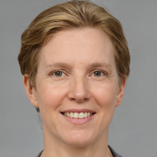 Joyful white adult female with medium  brown hair and grey eyes