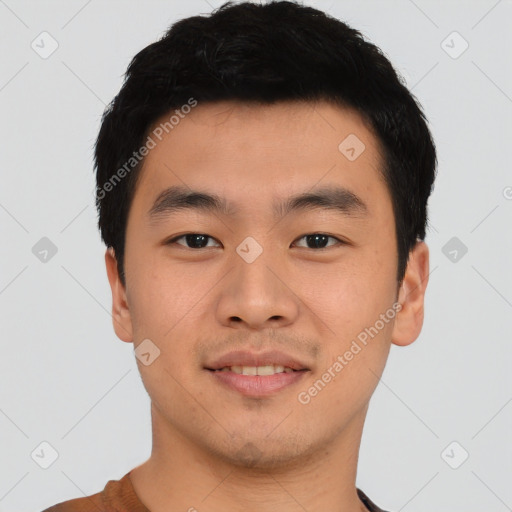 Joyful asian young-adult male with short  black hair and brown eyes