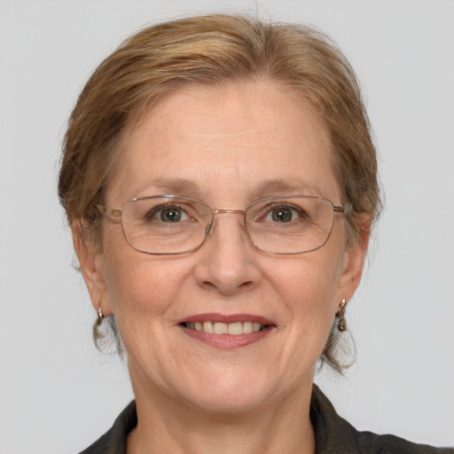 Joyful white middle-aged female with medium  brown hair and blue eyes