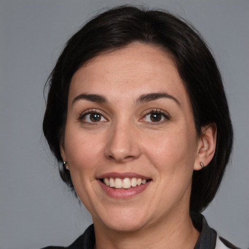 Joyful white adult female with medium  brown hair and grey eyes