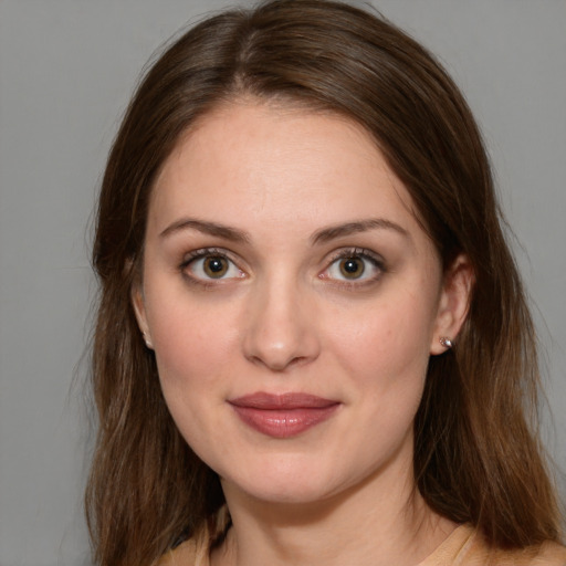 Joyful white young-adult female with medium  brown hair and green eyes