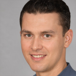 Joyful white young-adult male with short  brown hair and brown eyes