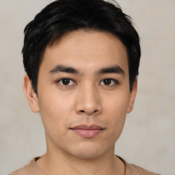 Joyful asian young-adult male with short  black hair and brown eyes