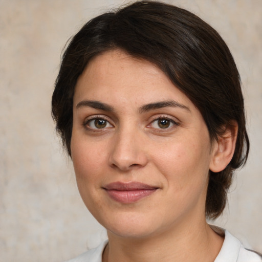 Joyful white young-adult female with medium  brown hair and brown eyes