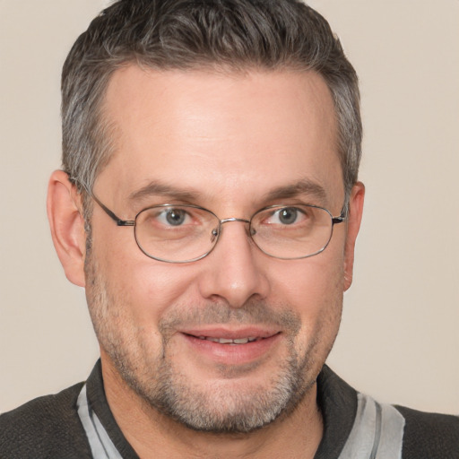 Joyful white adult male with short  brown hair and brown eyes