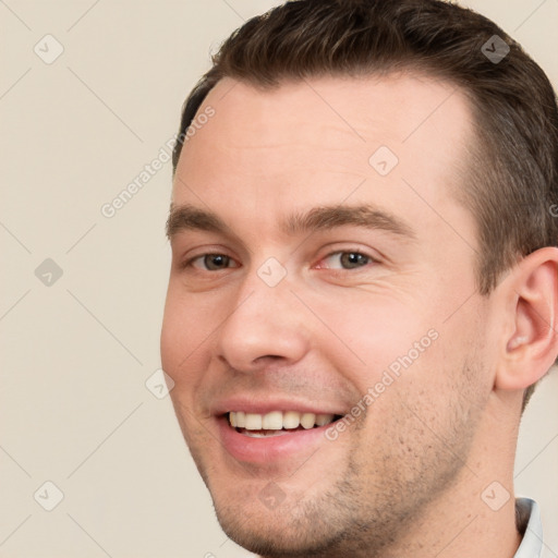 Joyful white young-adult male with short  brown hair and brown eyes