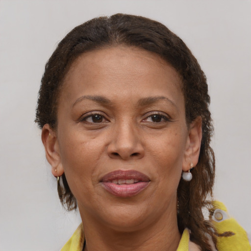 Joyful black adult female with short  brown hair and brown eyes