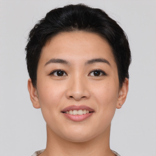 Joyful asian young-adult female with short  brown hair and brown eyes