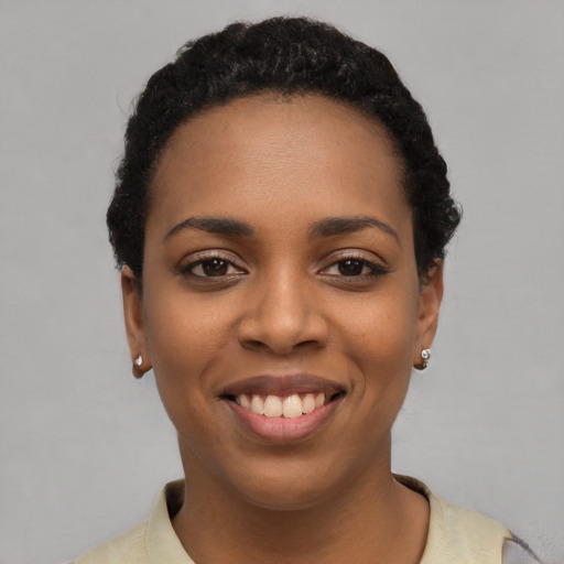 Joyful latino young-adult female with short  black hair and brown eyes