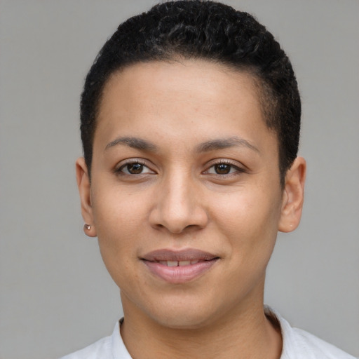 Joyful latino young-adult female with short  black hair and brown eyes