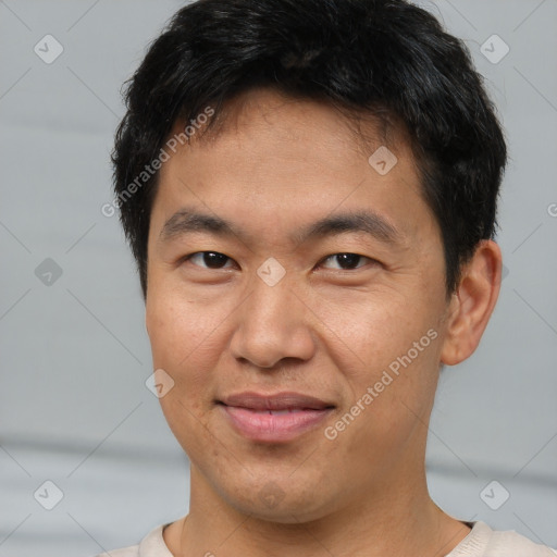 Joyful asian young-adult male with short  brown hair and brown eyes