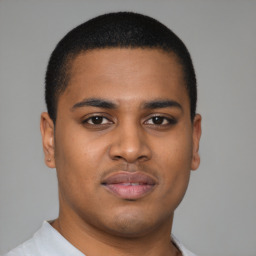 Joyful latino young-adult male with short  brown hair and brown eyes