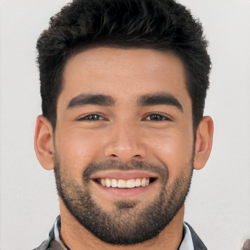 Joyful white young-adult male with short  black hair and brown eyes