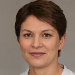 Joyful white adult female with short  brown hair and brown eyes