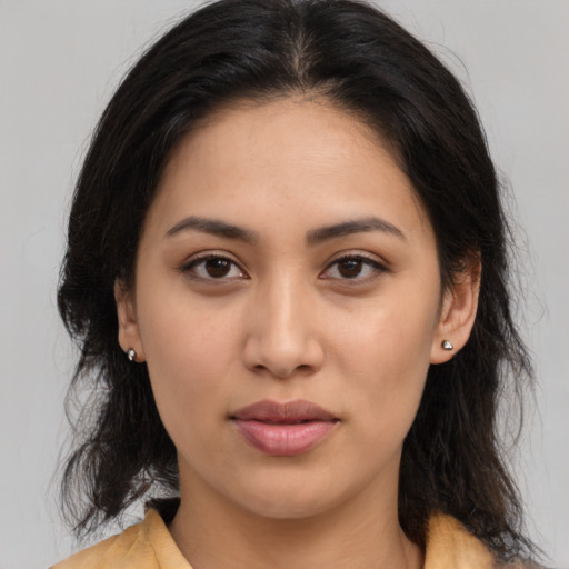 Neutral latino young-adult female with medium  brown hair and brown eyes