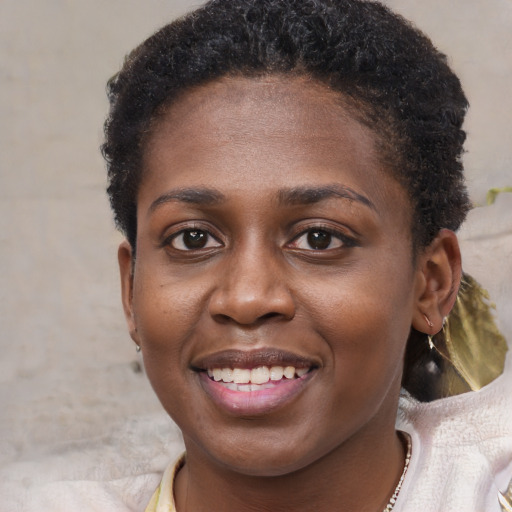 Joyful black young-adult female with short  brown hair and brown eyes